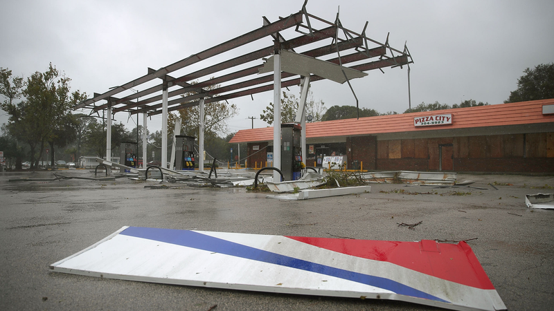Metal lies on the ground at a gas station damaged by the heavy winds of Hurricane Matthew, October 7, 2016 on Port Orange, Florida. Hurricane Matthew passed by offshore as a catagory 3 hurricane bringing heavy winds and minor flooding. (Image: Getty)